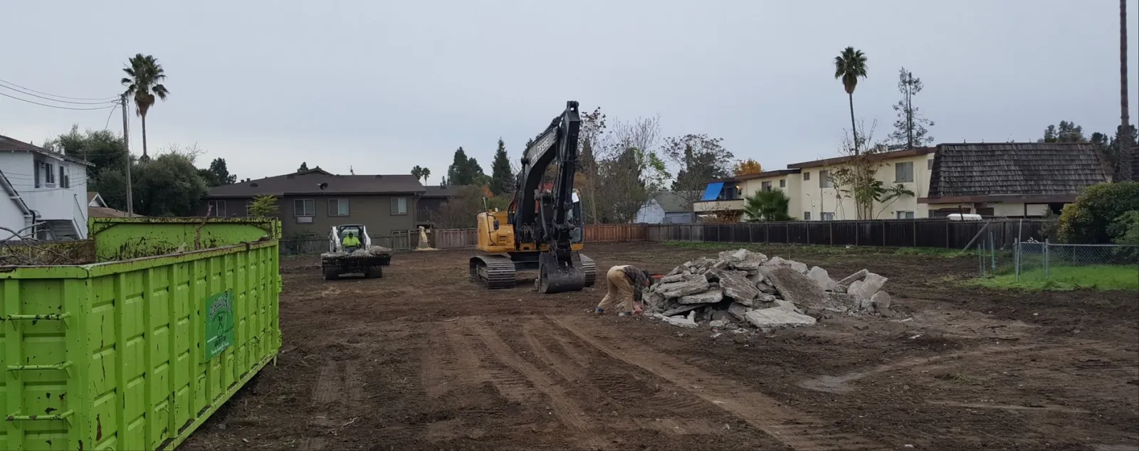Excavator and debris container on a Rebuild Green deconstruction site